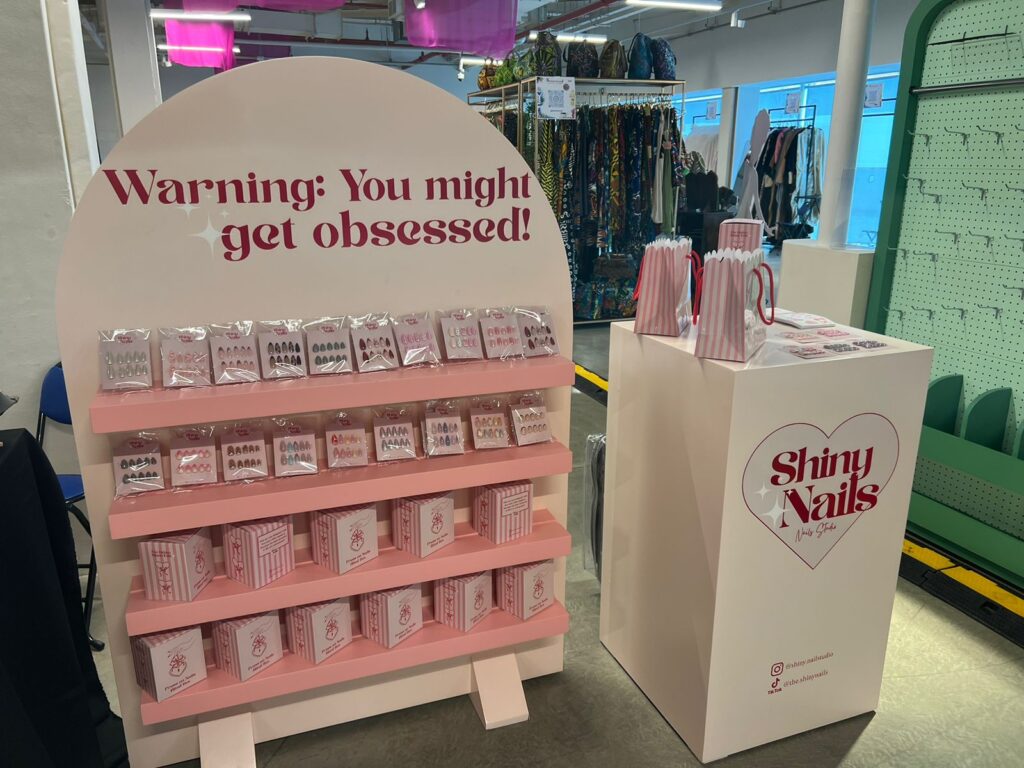 ستاند عرض Shiny Nails النهائي — pop-up display stand with branded counter and product shelves by Future Plan